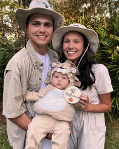 a man and woman are holding a baby