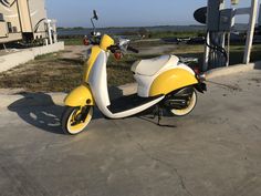 a yellow and white scooter parked next to an rv