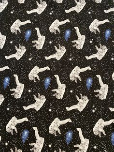 a black background with white and blue frogs floating in the air, surrounded by stars