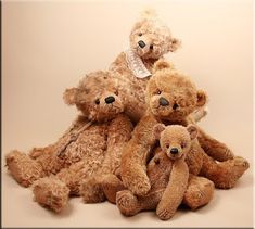 a group of brown teddy bears sitting next to each other on a white background,