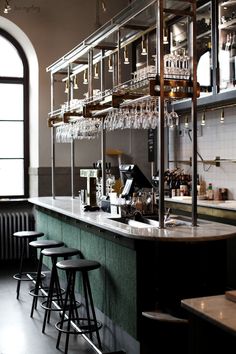 an empty bar with several stools in front of it