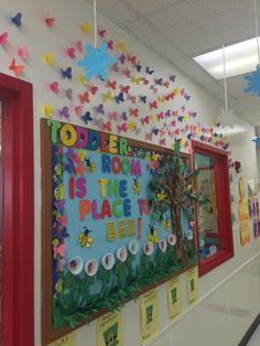 a bulletin board is decorated with colorful paper butterflies and the words toddler is the place to be