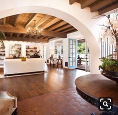 a living room filled with furniture and lots of wood flooring on top of a hard wood floor