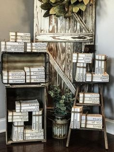 a bunch of books stacked on top of each other next to a potted plant