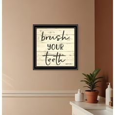 a bathroom wall hanging above a sink with a brush your teeth sign on the wall