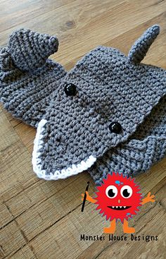 a crocheted elephant hat is laying on the floor next to a wooden floor