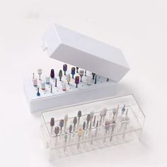 an assortment of toothbrushes in a display case on a white background with the lid open