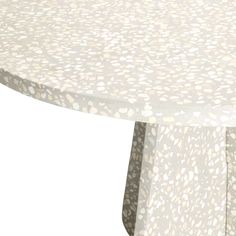 a round table with white and grey spots on it's surface, against a white background