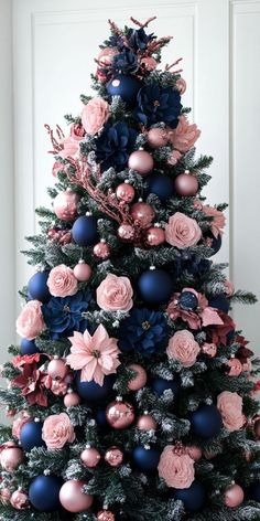 a christmas tree decorated with pink and blue ornaments