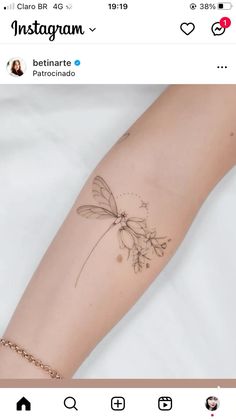 a woman's arm with a dragonfly tattoo on it