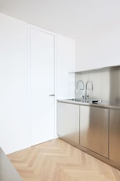 an empty kitchen with stainless steel appliances and cabinets