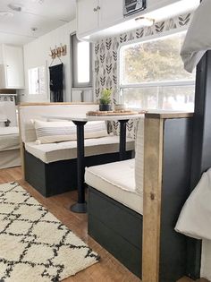 the interior of a mobile home with black and white decor