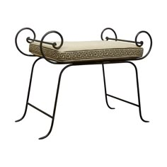 an iron bench with a cushion on it