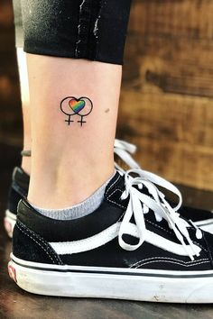 a woman's foot with a small tattoo on her left ankle and the word i love