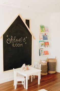 a child's playroom with chalkboard and toys