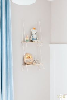 two shelves with toys on top of them in a child's room, one is white and the other is blue