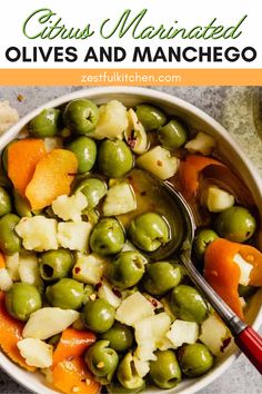 a bowl filled with green olives and carrots