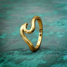 This stunning Gold Wave Ocean wedding band bridal ring is a true masterpiece that captures the essence of the sea. Crafted with intricate details resembling gentle waves dancing in the ocean, this unique ring symbolizes everlasting love and eternal commitment. The shimmering gold adds a touch of elegance and luxury, making it the perfect choice for your special day. Whether you're planning a beach or nautical-themed wedding, this exquisite ring will be a beautiful reminder of your love story. Ad Wave Wedding Band, Rosé Model, Nautical Wedding Theme, Ocean Wedding, Gold Waves, Bronze Jewelry, Bridal Bands, Unique Ring, Beach Inspired