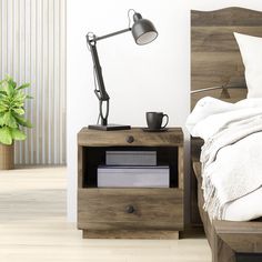 a bedroom with a bed, nightstand and lamp on the side table next to it