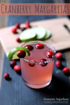 cranberry margarita with lime, cucumber and cranberries on the side