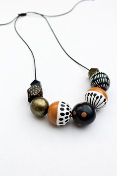 Brighten up your day with this wooden large bead necklace. It's chunky, funky and colorful so it's a real statement piece.  This one is a combination of mustard yellow, white, dark blue, and dark green heaps of different sized polka dots, stripes plus flower design. The size of the beads goes from 13 mm to 30 mm. The cord is waxed polyester. It's flexible yet durable. The sliding knot will enable you to adjust the length in no time. The maximum length is 90 cm or 35 inches. If you like the style Wood Beads Jewelry, Chunky Bead Necklace, Large Bead Necklace, Floral Statement Necklace, Necklace Wood, Chunky Bead Necklaces, Wooden Bead Necklaces, Large Beads, Green Beaded Necklace