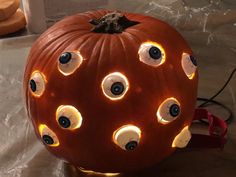 a pumpkin with eyes on it sitting on a table