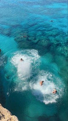 several people swimming in the blue water