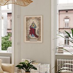 a living room filled with furniture and a painting hanging on the wall next to a window