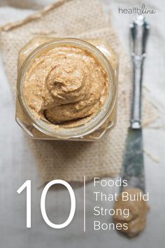 a glass jar filled with food sitting on top of a table next to a spoon