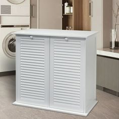 a large white cabinet next to a washer and dryer in a laundry room