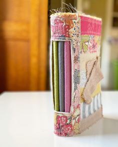 a close up of a book on a table with other books in the back ground