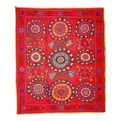 a red rug with many circular designs on the front and sides, all in different colors