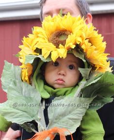 a young child wearing a sunflower hat