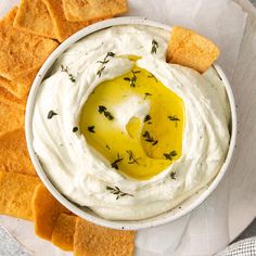 a white bowl filled with dip and crackers