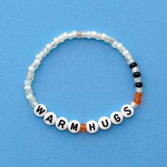 Warm Hugs bracelet! Handmade with love using Czech glass beads, white and black letter beads and stretch cord. Get creative! All my bracelets are meant to be mixed, matched & stacked!  SIZING: Measure your wrist around the widest point and add .25-.5 inches to get the most comfortable or desired fit. If you don't have a flexible tape measure, you can use a piece of string to wrap around your wrist and then measure the length of the string. (For example: my wrist size is 6" and I will wear a 6.5" bracelet for a snug fit and 7" for a loose fit). CARE INSTRUCTIONS: Please be careful to not overstretch bracelets too far. They are made out of a durable elastic string but are still capable of breaking if not handled carefully. Avoid submerging bracelets in water and store in a dry place. I'd lov Disney Friendship Bracelet Ideas, Disney Bracelet Ideas, Disney Friendship Bracelet, Miranda Core, Disney Friendship, Disney Bracelets, Disney Bands, Cute Friendship Bracelets, Homemade Bracelets