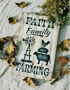 a sign that says, faith family farming on it next to some leaves and flowers