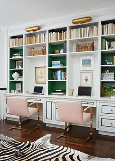 a zebra rug is on the floor in front of two desks and bookshelves