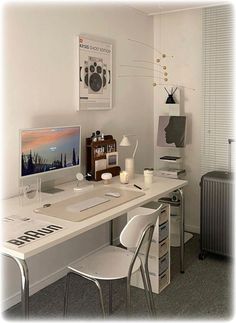 a white desk with two chairs and a computer monitor on it, next to a radiator