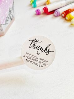 a thank stick with writing on it next to crayons