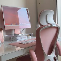 a desk with a computer, keyboard and phone on it