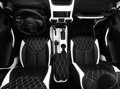 the interior of a car with black and white leather