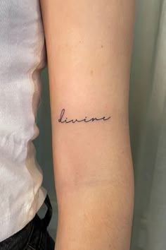 a woman with a small tattoo on her arm that says, be brave in cursive writing