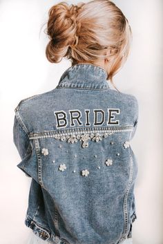 a woman wearing a denim jacket with the word bride written on it