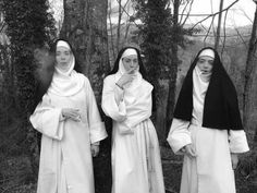 three women dressed in nun costumes standing next to each other