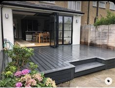 a backyard deck with steps leading up to the dining room