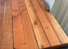 a wooden table top sitting next to a white radiator