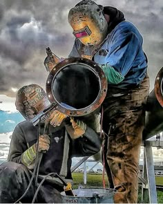 two men are playing instruments in front of a cloudy sky