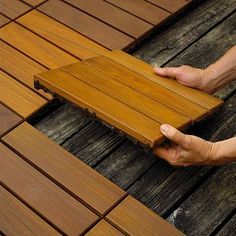 a person laying on top of a wooden floor next to another person's feet