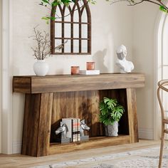 a wooden shelf with two vases on top of it next to a potted plant