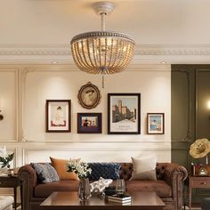 a living room filled with furniture and pictures on the wall